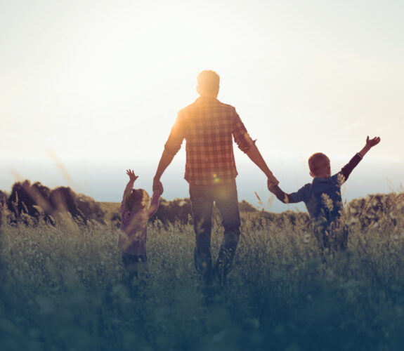 family frolicking in a field