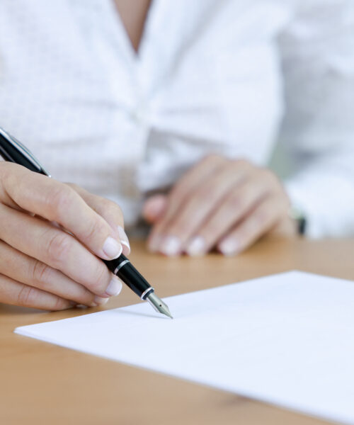 Businesswoman signing an official document